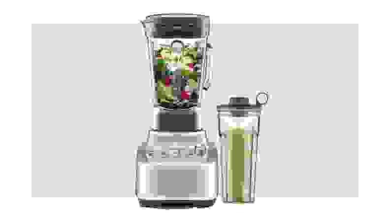 Breville Super Q blender and attachments on beige background