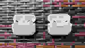The white AirPods Pro case sits open next to the very similar AirPods Pro (2nd gen) case