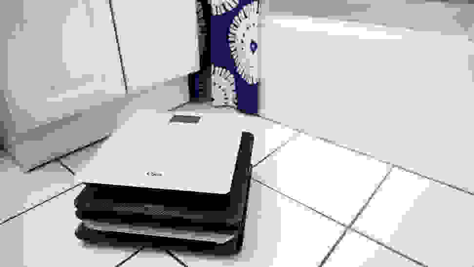 A stack of scales on a bathroom floor