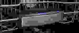 A close-up of the front of a Bosch dishwasher's top rack, which has the Bosch logo on it.