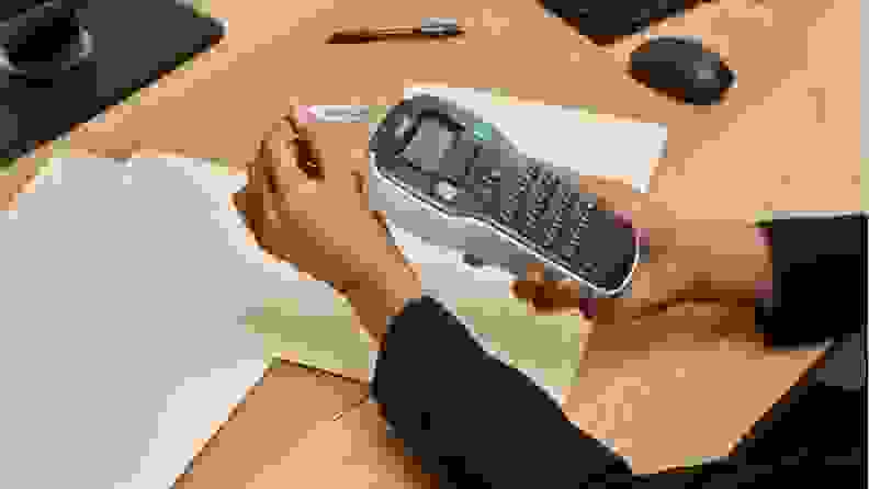 A person holds a Dymo LabelManager 160 portable label maker.