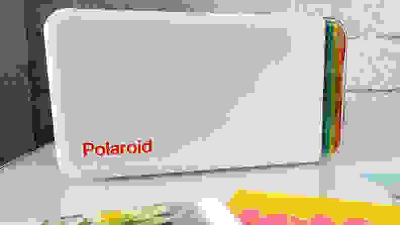 The Polaroid Hi-Print portable photo printer sitting on a counter top.
