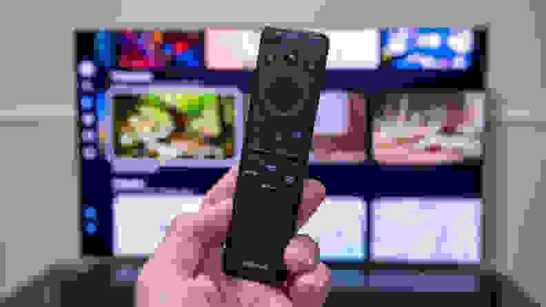 A remote control in front of A Samsung television screen with bright colors