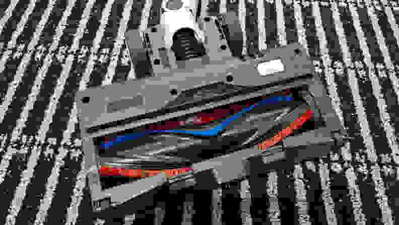 A vacuum head upside down with full view of the roller brush