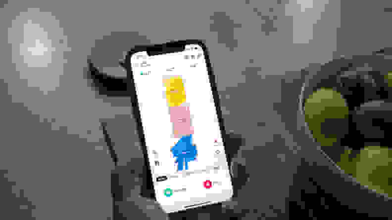 The Ultenic app on a phone with the MC1 in the background.