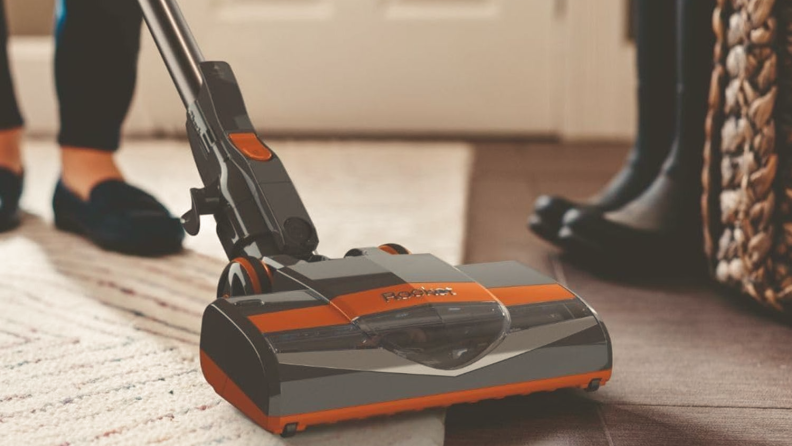 A gray-and-orange Shark Rocket stick vacuum.